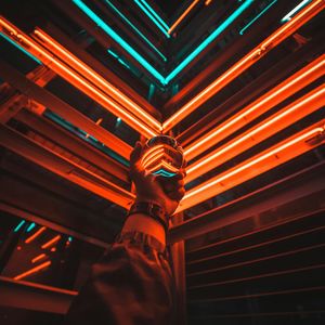 A glass of water with neon blue reflections.