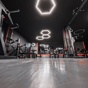 Empty minimalist workout room with blue light strips.